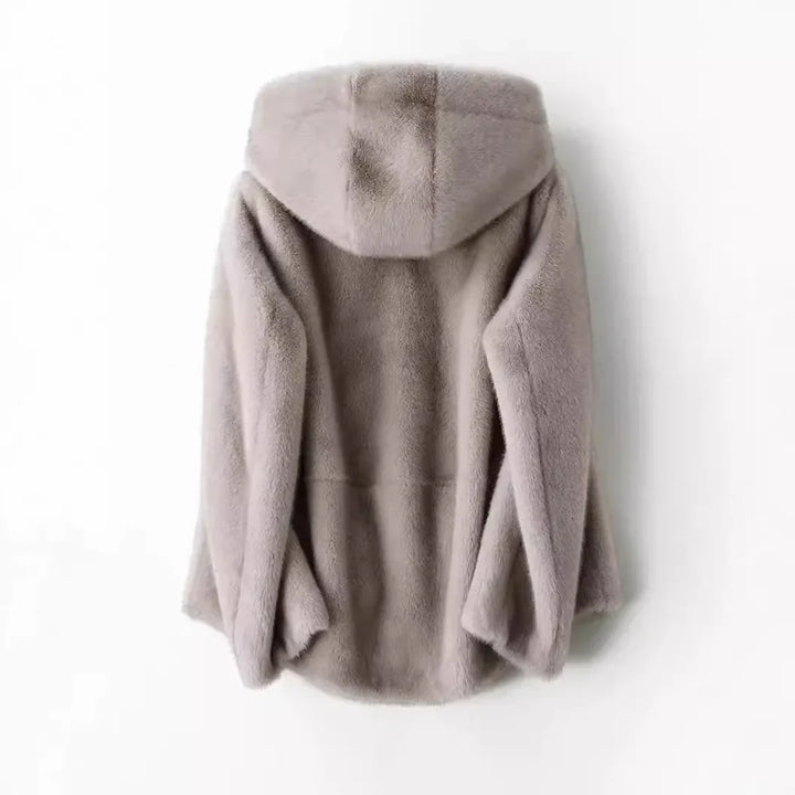 Detailed view of the soft faux fur and hood on a women's winter jacket, warm outerwear