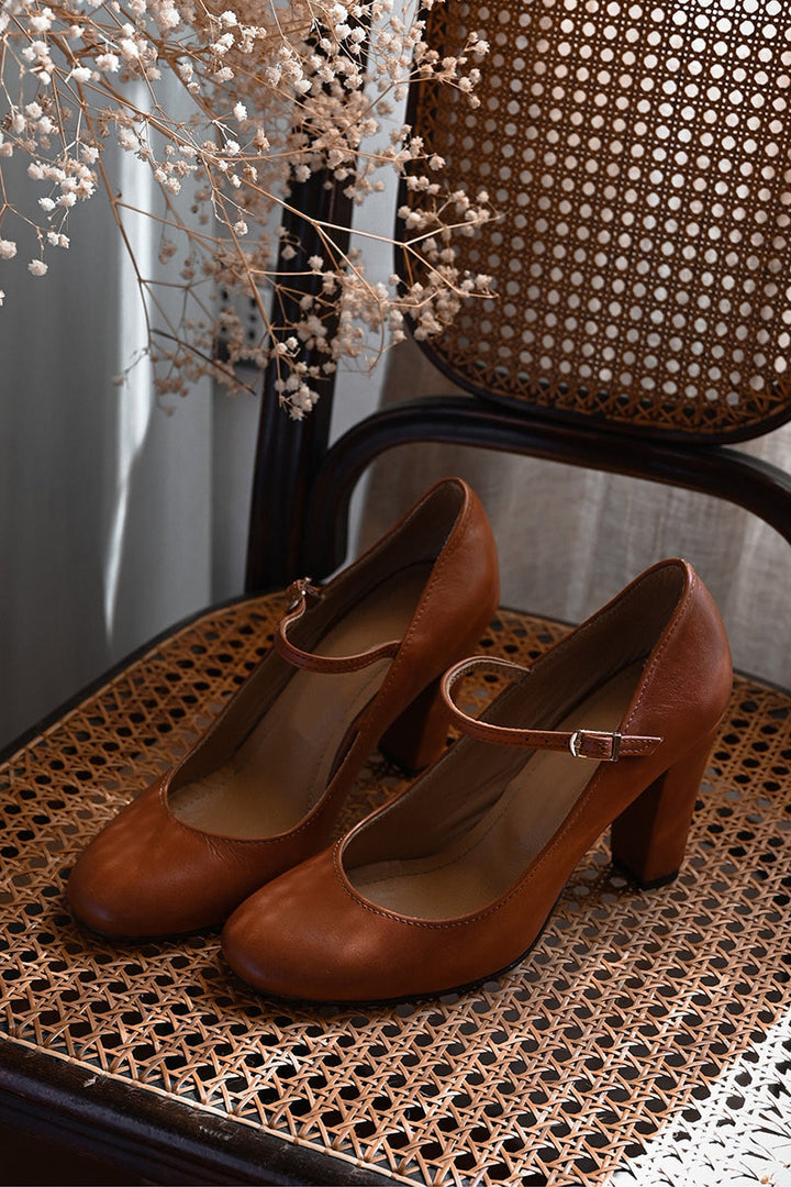 Stylish brown women's Mary Jane heels. Comfortable block heel, rounded toe, and classic instep strap design.