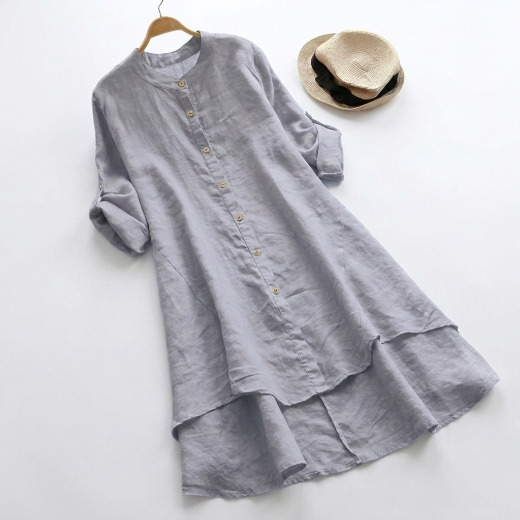Close-up of women's button-down shirt dress, showing layered hem & long sleeves. Comfortable midi, ideal for all seasons.