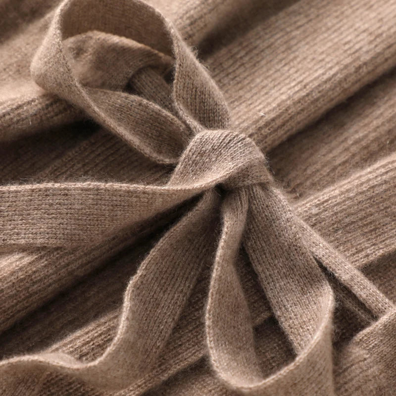 A woman wearing a cozy cashmere blend belted knit vest as a chic layer
