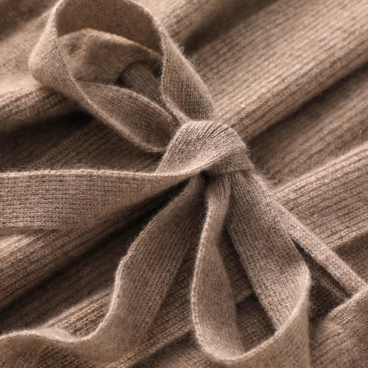 A woman wearing a cozy cashmere blend belted knit vest as a chic layer