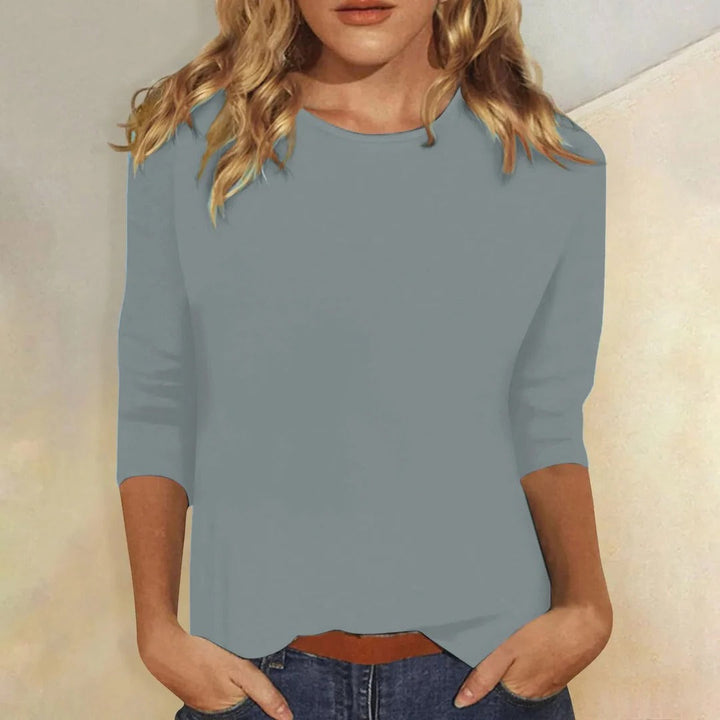 Fashionable women's crew neck top, featuring 3/4 sleeves and a relaxed fit for comfortable casual wear.