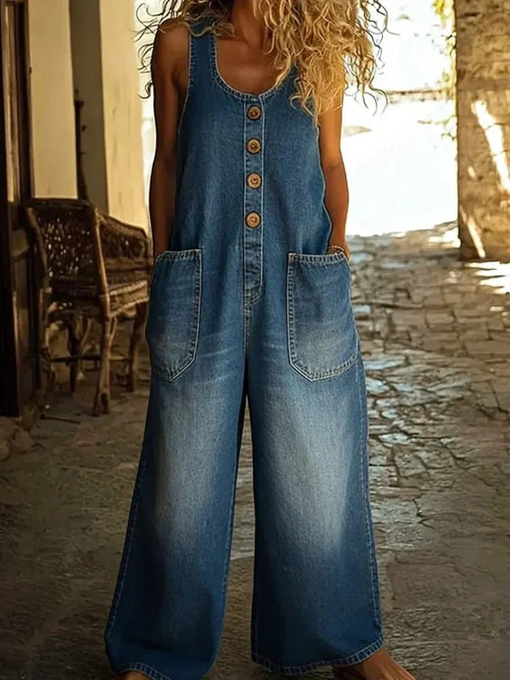 Stylish women's denim overalls, scoop neck, sleeveless, button-front, loose fit. Comfortable spring & summer fashion.