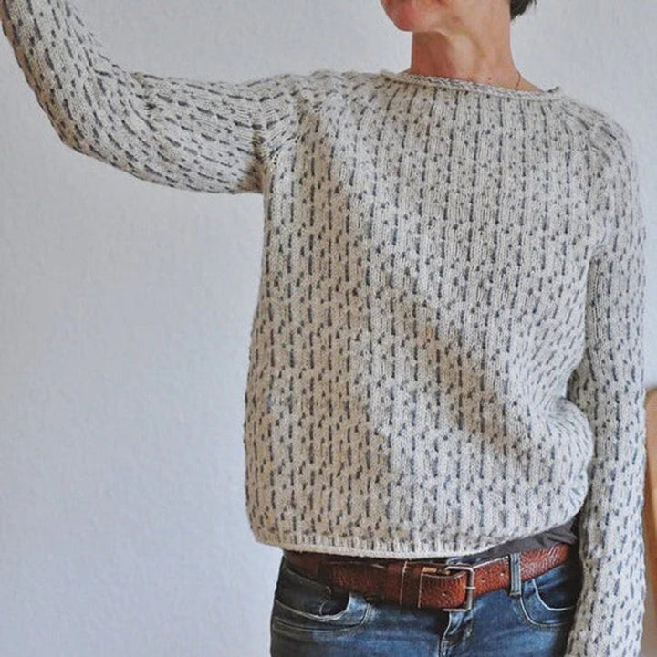 Versatile grey knit sweater with a boat neck, offering a chic and casual look for women.