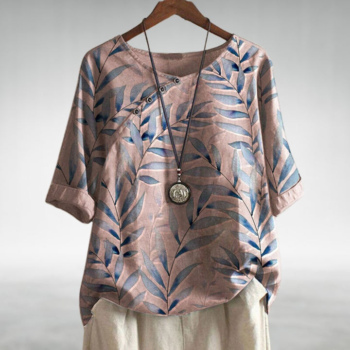 Lightweight women's casual blouse with vibrant leaf print, button-up front, and relaxed fit