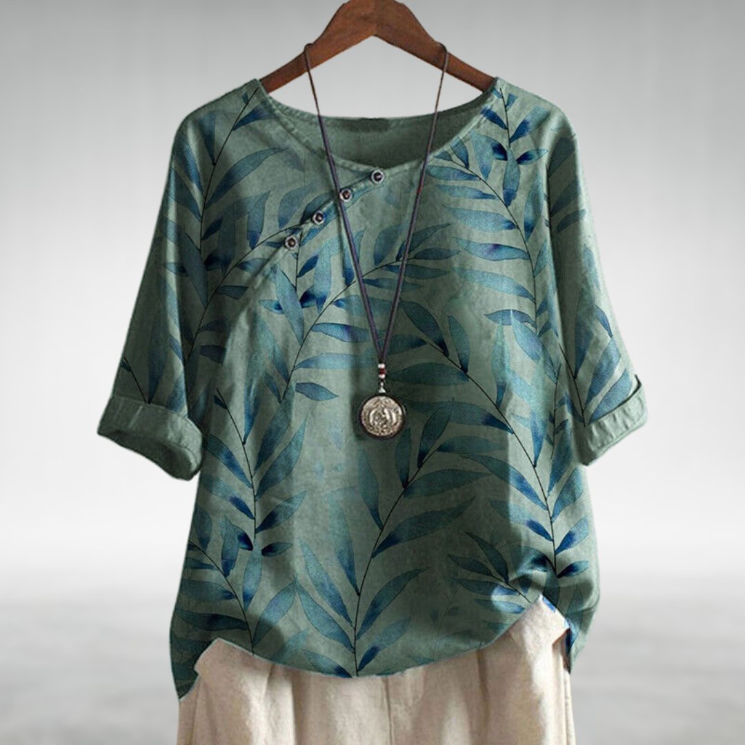 Floral print women's short sleeve blouse with button-up closure, offering a comfortable relaxed fit