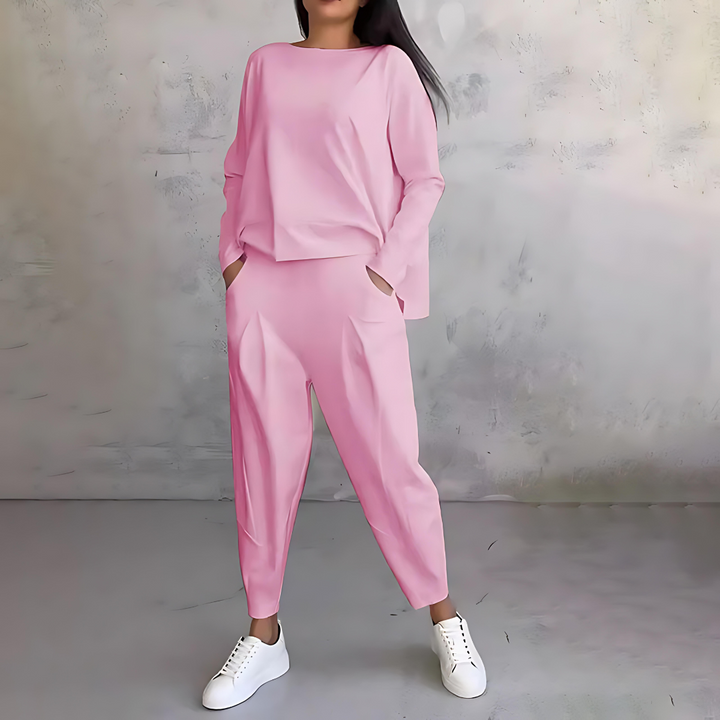 Women's elegant casual outfit: loose-fit long sleeve top paired with comfortable tapered pants.