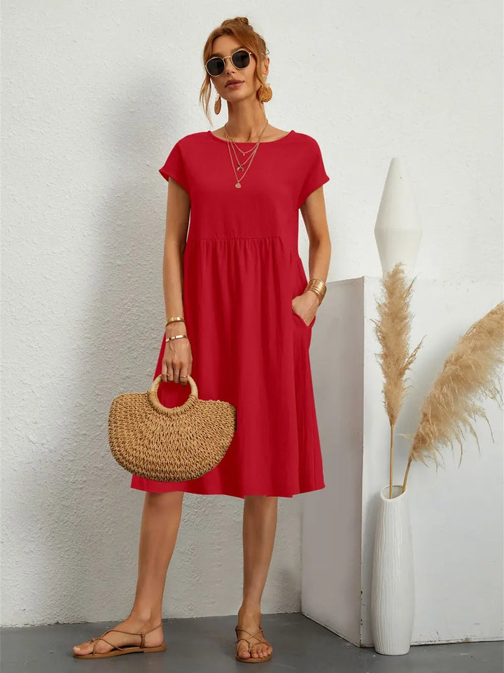 Women's casual midi dress with pockets, short sleeve, and round neck for effortless everyday style.