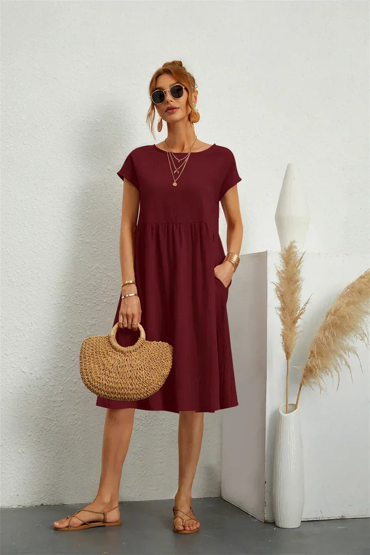 Women's casual midi dress with practical pockets and short sleeves, an everyday fashion staple.