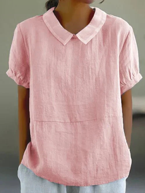 Comfortable women's short sleeve top with Peter Pan collar. Versatile casual blouse for everyday chic style.