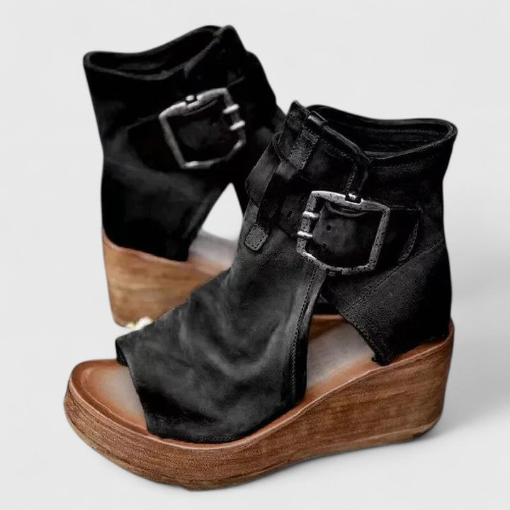 Stylish women's slip-on comfort loafers with a subtle wedge heel and decorative buckle.