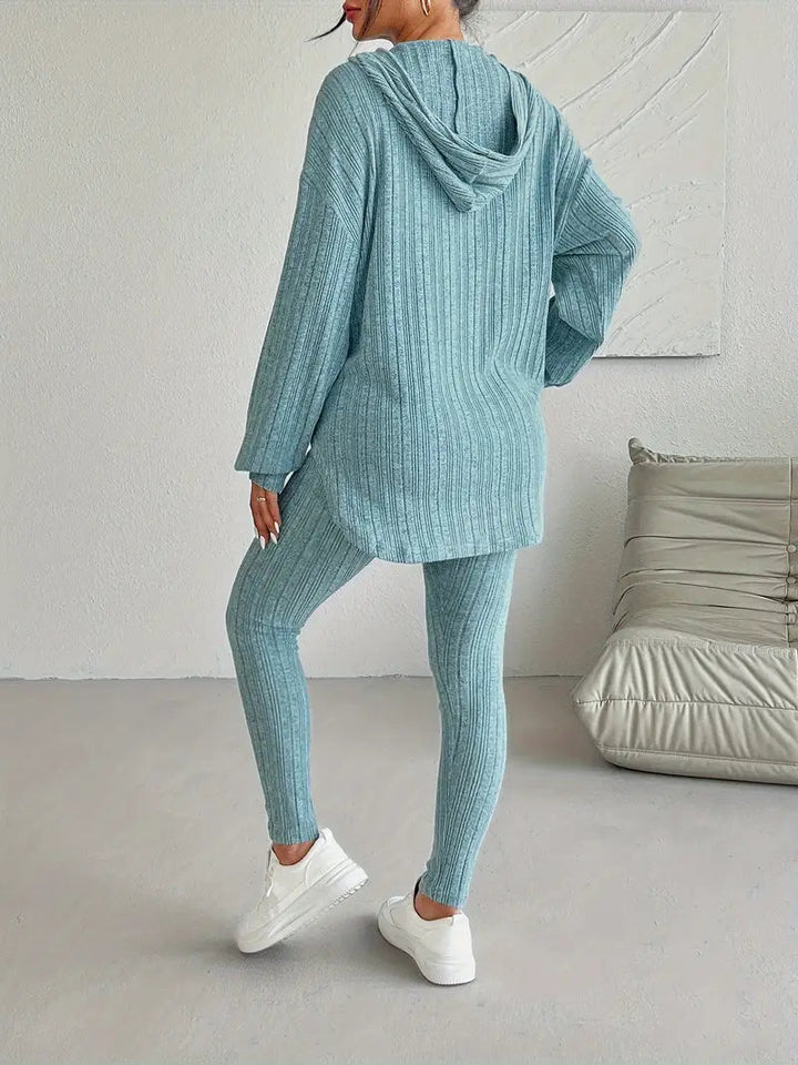 Side profile of a woman wearing a black ribbed knit two-piece loungewear set; casual and chic