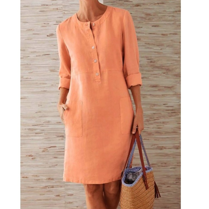 Versatile knee-length women's shift dress with button-front design and convenient side pockets.