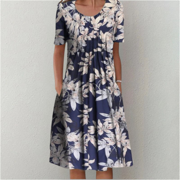 Women's elegant floral midi dress, ideal for summer occasions. Features short sleeves & pockets.