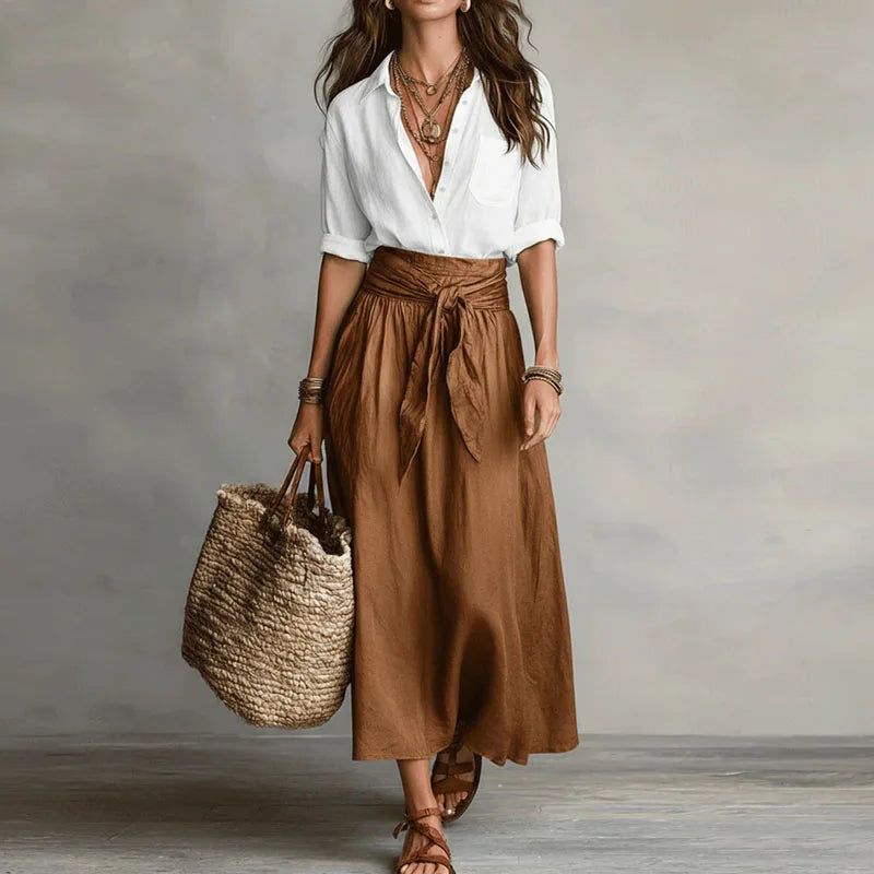 Stylish women's two-piece skirt suit featuring a long sleeve top & a tie-waist skirt, ideal for casual outfits.