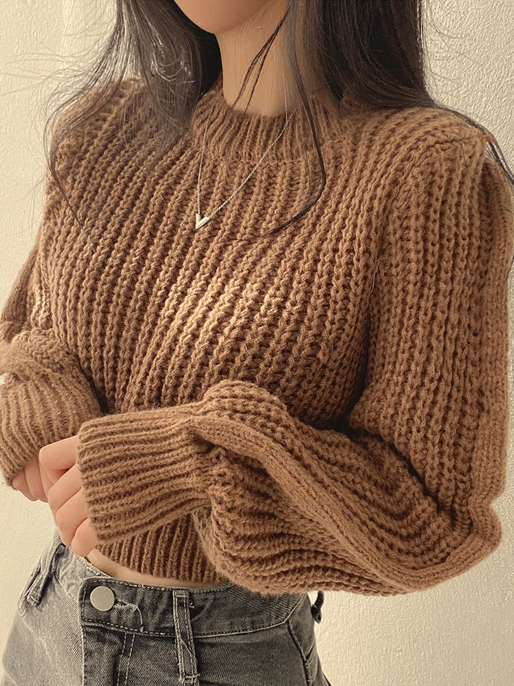 Back view of a women's chunky knit lantern sleeve sweater, showcasing its relaxed fit and warmth