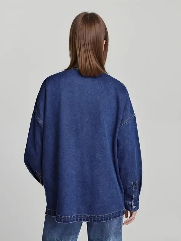 Model wearing an oversized women's denim jacket, ideal for layering and spring fashion.