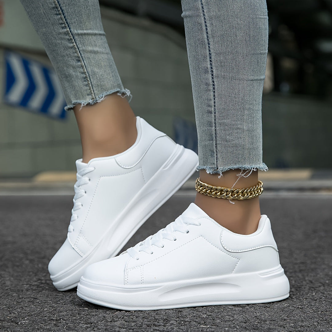 New women's clean white low-top sneakers. Modern design, comfortable for everyday wear & versatile casual shoes.