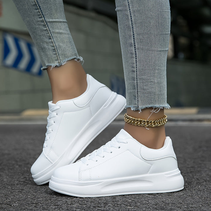 New women's clean white low-top sneakers. Modern design, comfortable for everyday wear & versatile casual shoes.