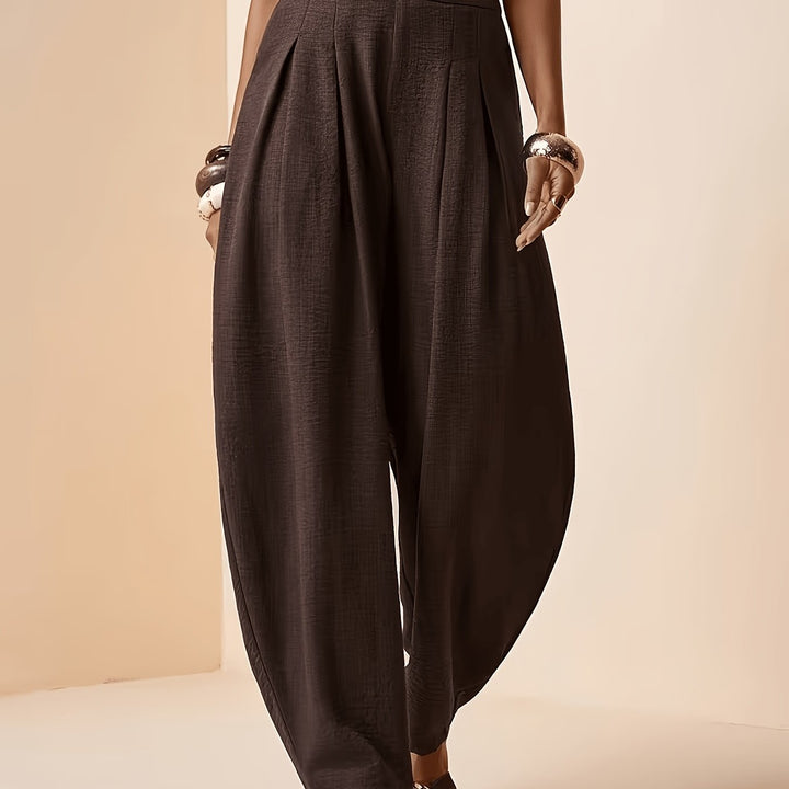 Versatile women's coffee brown harem pants. High-waist, pleated front, & tapered ankle for a chic, relaxed fit.