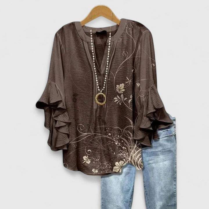 Elegant women's floral print blouse with stylish ruffle sleeves. Comfortable and perfect for spring/summer casual chic.