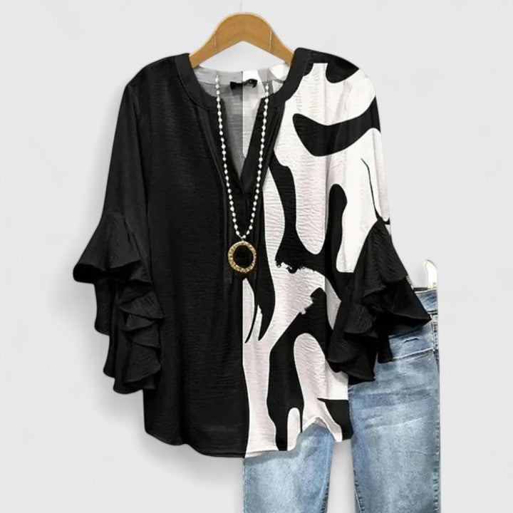 Comfortable plus size women's floral print blouse. Ruffle sleeves offer an elegant touch for versatile spring style.