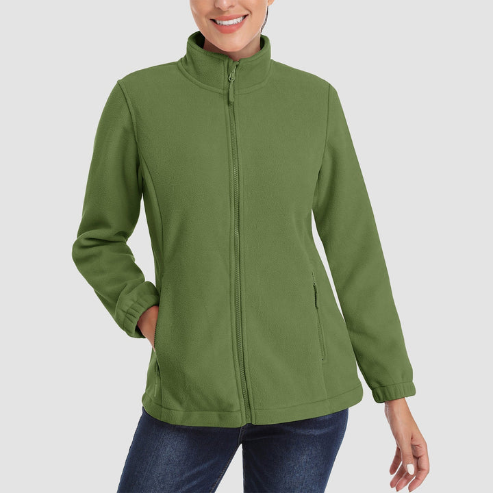 Model smiling while wearing a light blue women's full-zip fleece jacket, embracing fall fashion