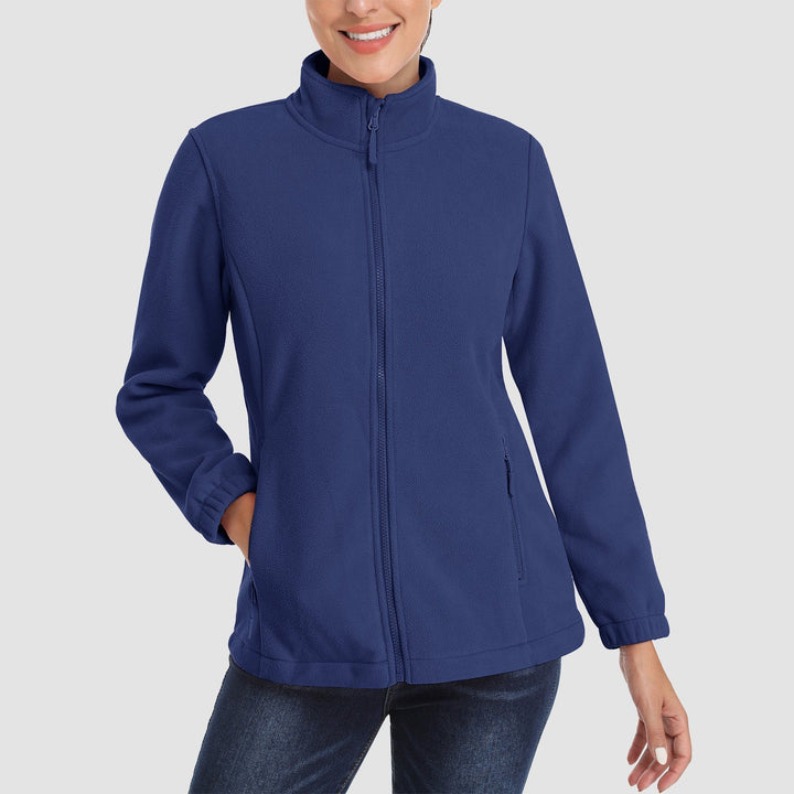 Folded women's fleece jacket, full zip, in a stack of everyday outerwear, ready for winter