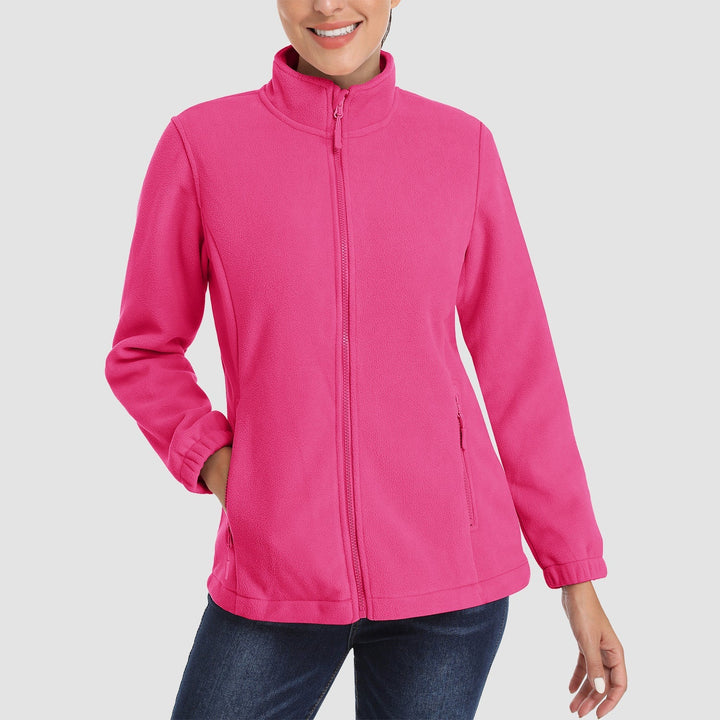 Woman enjoying a bonfire while wearing a cozy brown full-zip fleece jacket, ideal winter outerwear