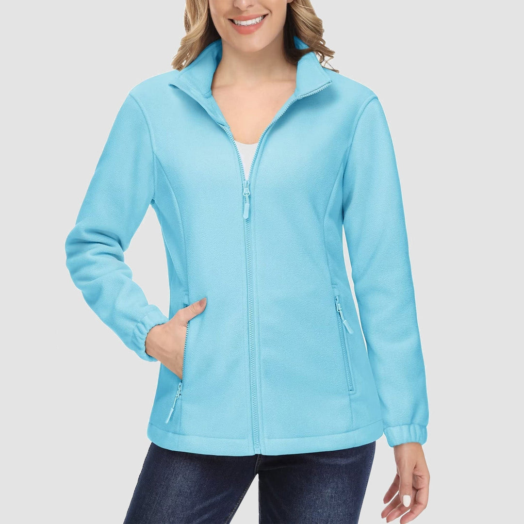 Woman walking in a park, wearing a stylish olive green full-zip fleece jacket, perfect for autumn