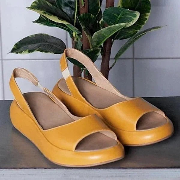 Lightweight women's slip-on sandals with open toe design and elastic band for easy warm weather wear.