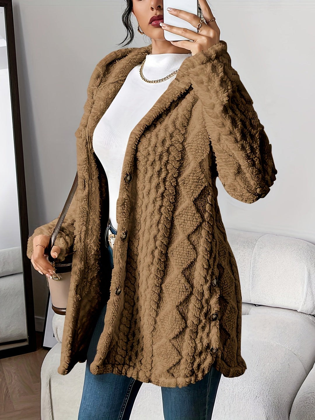Effortless women's long hooded coat. Stylish button-front, textured design, ideal for winter style.