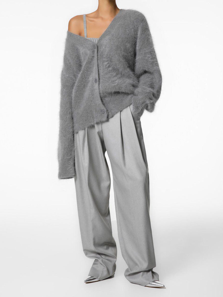 Women's oversized cardigan draped over a chair, inviting and cozy, perfect loungewear