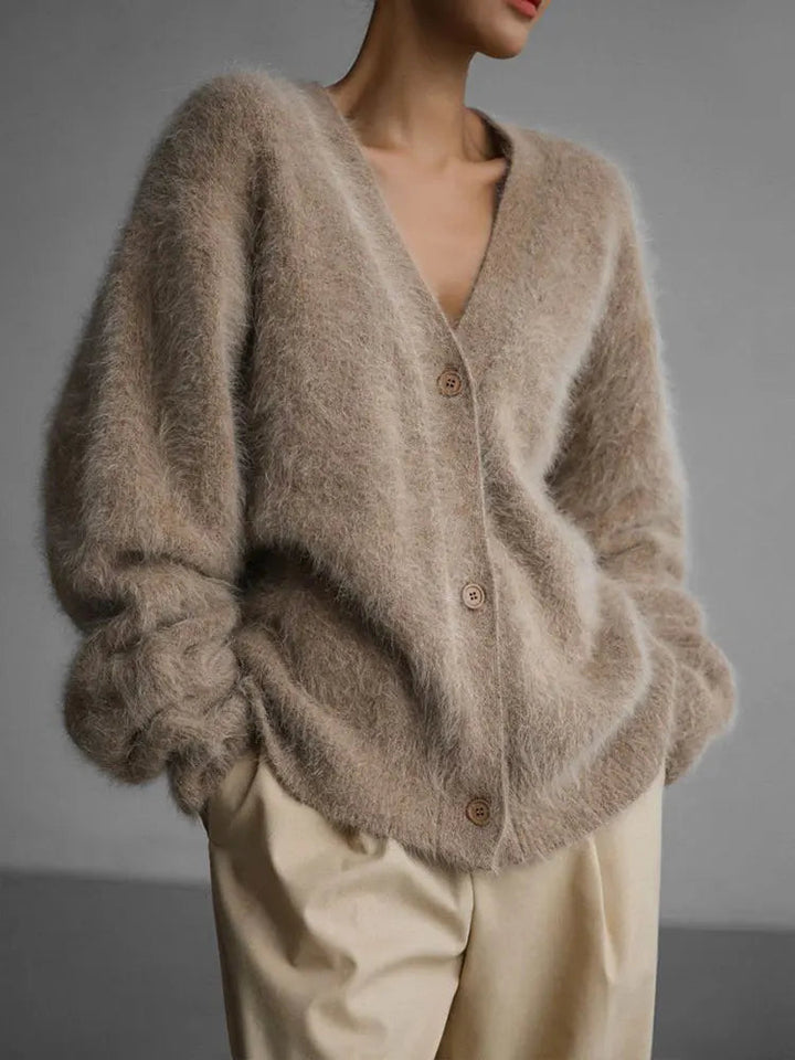 Close-up of the luxurious knit texture of a women's oversized cardigan, soft and cozy