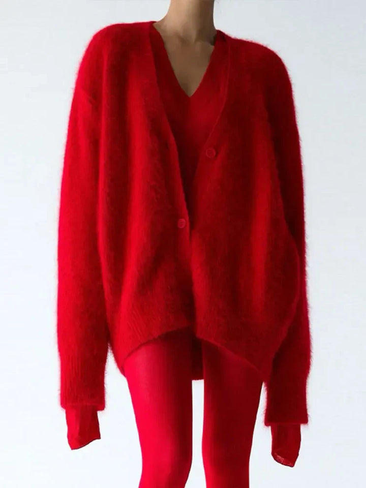 Woman reading a book, wrapped in a cozy knit oversized cardigan, ultimate comfort