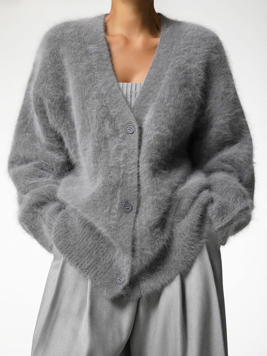 Model wearing a beige women's cozy knit oversized cardigan with jeans, comfortable and stylish