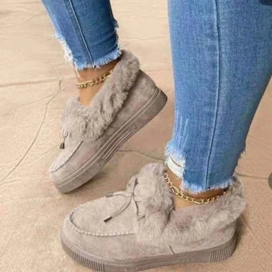 Women's cozy lined round toe slip-on shoes for warm winter comfort.