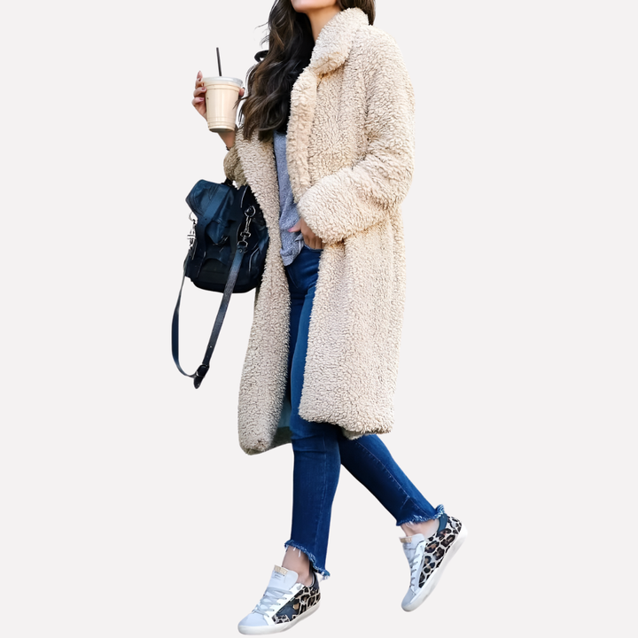 Woman wearing a cozy longline teddy coat, embracing stylish winter fashion and relaxed outerwear comfort.