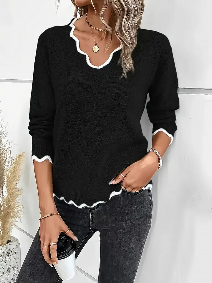 Woman wearing a relaxed fit long sleeve pullover with a stylish notch V-neck design.