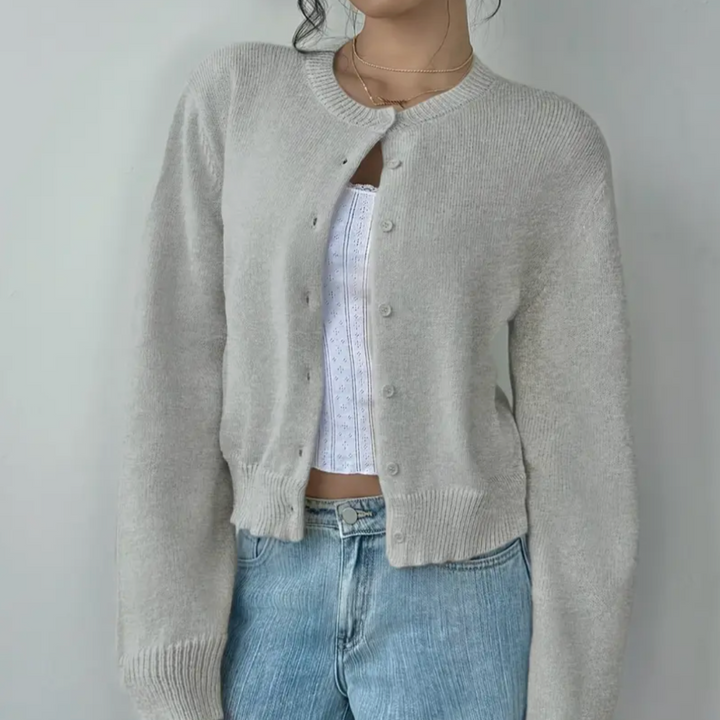 Solid color women's cropped cardigan with a neatly aligned button-front closure, spring fashion.