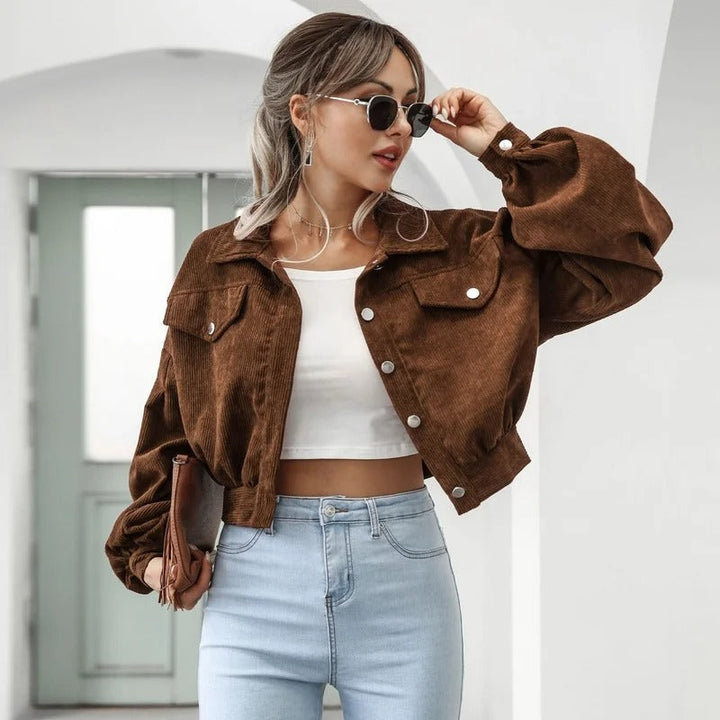 Light women's cropped denim jacket with puffed sleeves, comfortable & chic for warm weather style.
