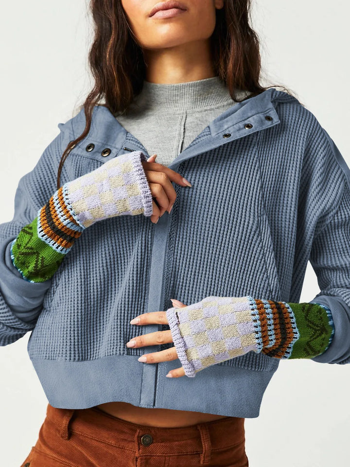 Studio shot of a women's cropped waffle-knit zip hoodie, showcasing fabric and cut