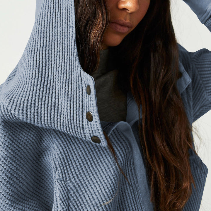 Detailed view of the drawstring on the hood of a women's waffle-knit cropped hoodie