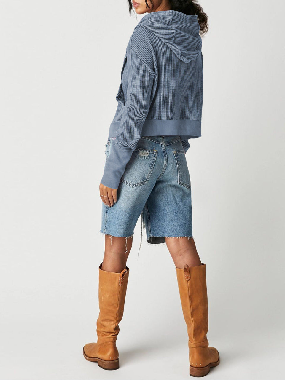 Model smiling while wearing a comfortable cropped waffle-knit zip hoodie, happy vibe