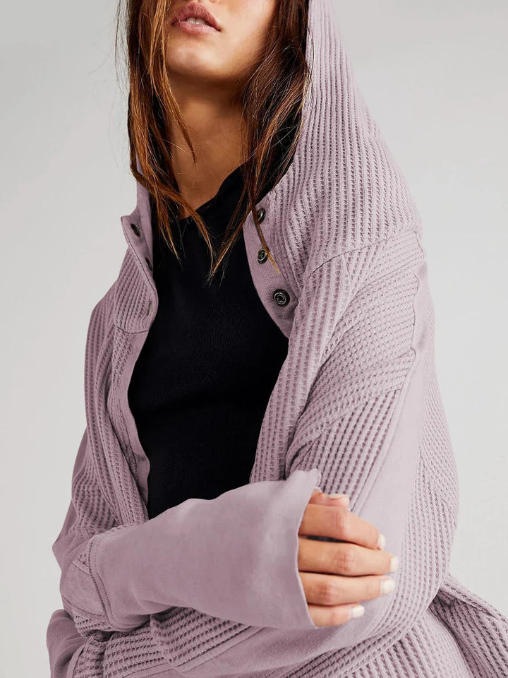 Lifestyle shot of a woman enjoying coffee in her cropped waffle-knit zip hoodie