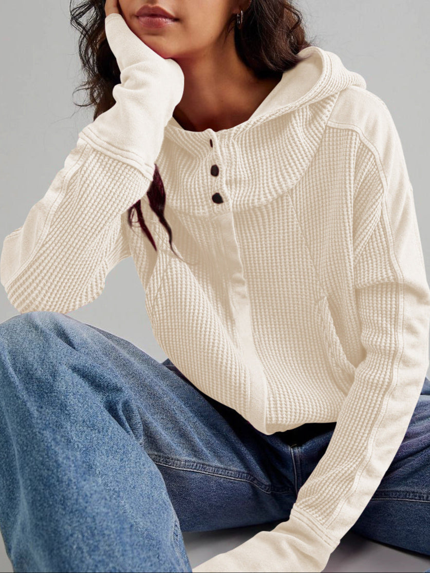 Flat lay of women's cropped waffle-knit zip hoodie with tag, product details visible