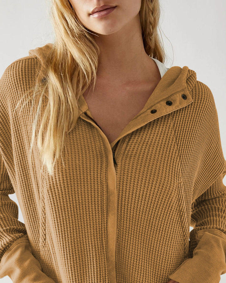 Stylized shot of a women's cropped waffle-knit zip hoodie, showcasing its fashion appeal