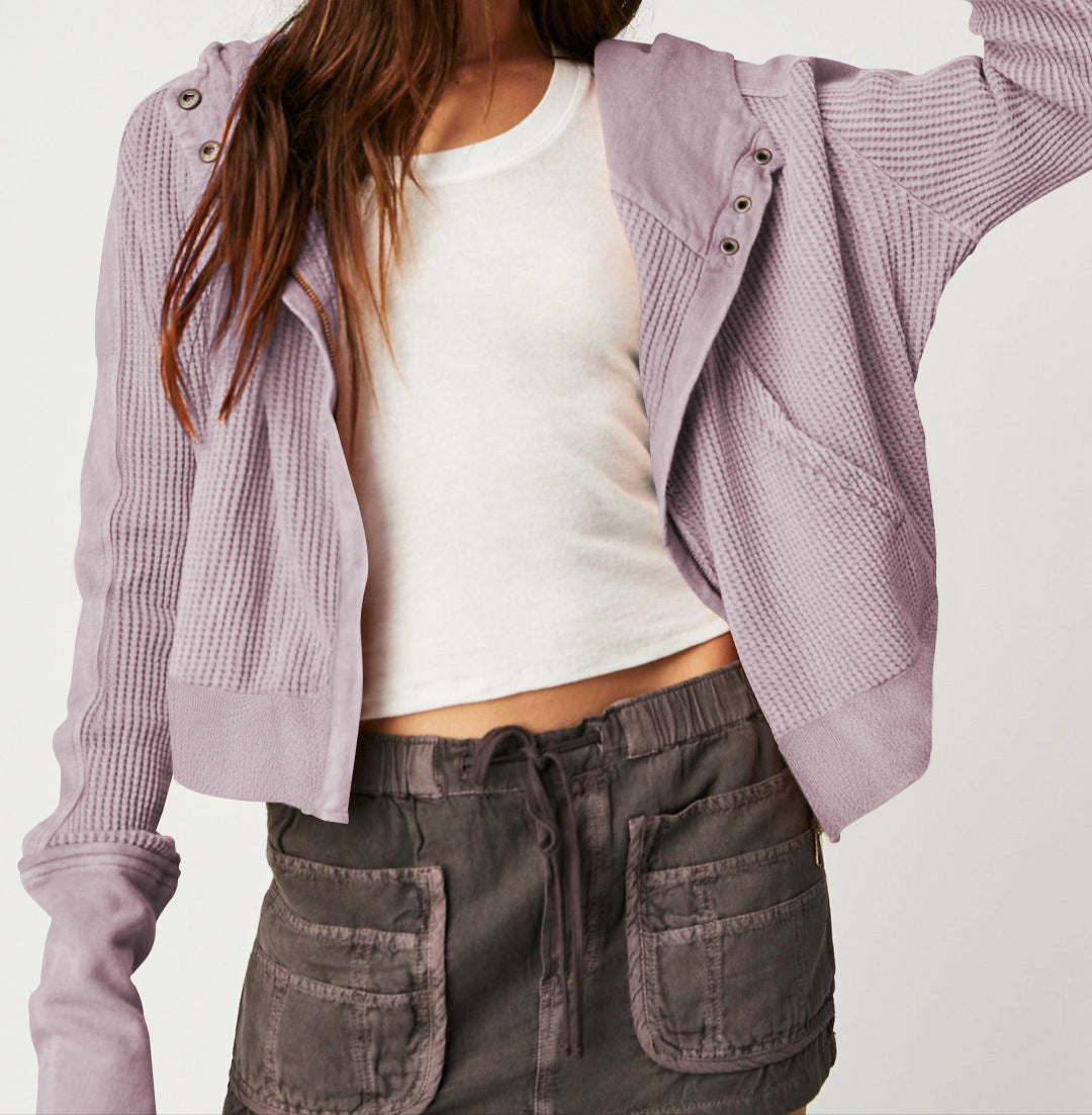 Side view of a model in a gray cotton cropped waffle-knit zip hoodie, comfortable fit