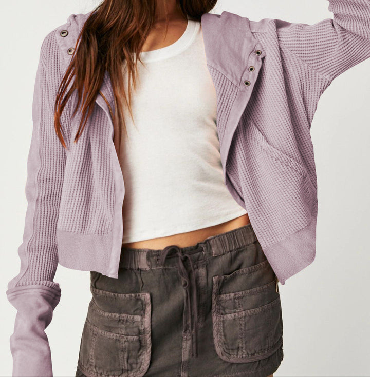 Side view of a model in a gray cotton cropped waffle-knit zip hoodie, comfortable fit