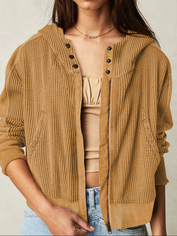 Detail of silver zipper on women's cropped waffle-knit hoodie, quality casual wear